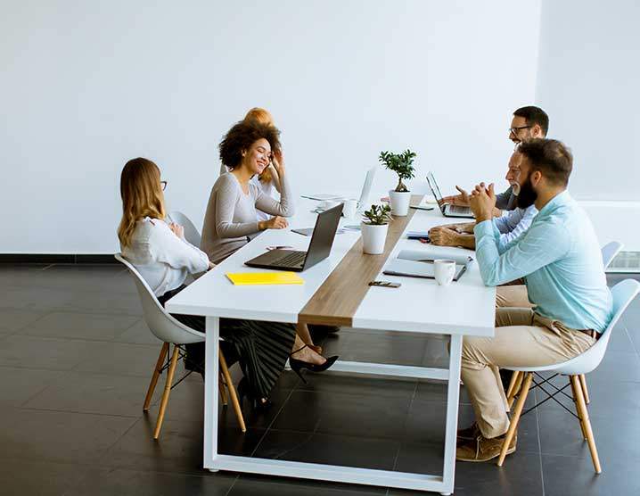 Six employees sharing a work table
