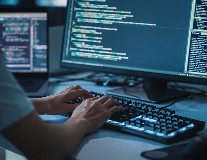 A person coding at their desktop