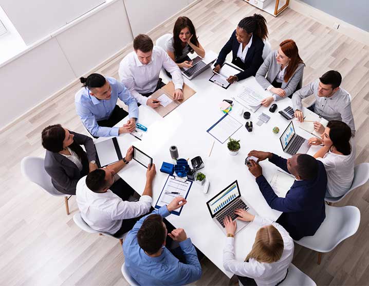 Twelve people working around a large table
